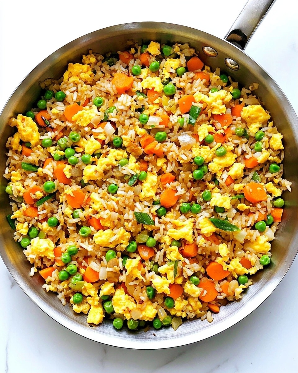 A close-up image of a bowl filled with fried rice showing multiple layers of ingredients. The base layer is golden brown rice mixed with small green peas, bright yellow scrambled egg pieces, and chunks of red bell pepper scattered evenly throughout. There are also pieces of cooked onion and green onion slices mixed in, adding texture and color. A woman's hand with wooden chopsticks is picking up some rice from the bowl. The bowl is white, set against a white marbled textured background. Photo taken with an iphone --ar 4:5 --v 6.1
