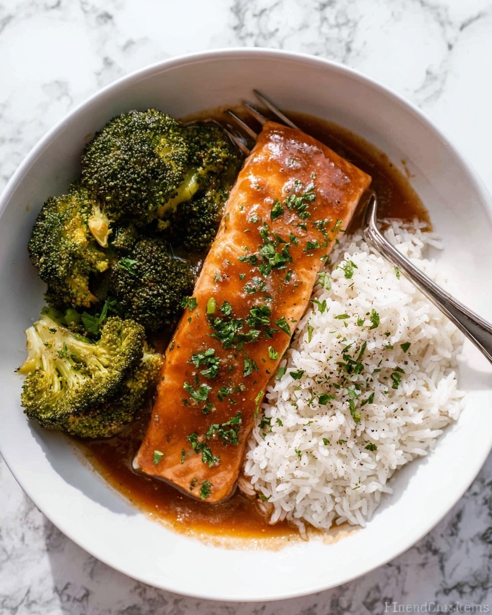 A white bowl holds a serving of white rice on the right side, with each grain fluffy and slightly separated. Next to the rice, in the center is a piece of cooked salmon covered in a shiny, reddish-brown sauce sprinkled with green herbs. On the left and right edges of the plate, bright green steamed broccoli florets add a fresh contrast. A silver fork rests on the right edge of the bowl, partly on the broccoli and rice. The bowl sits on a white marbled surface. photo taken with an iphone --ar 4:5 --v 7