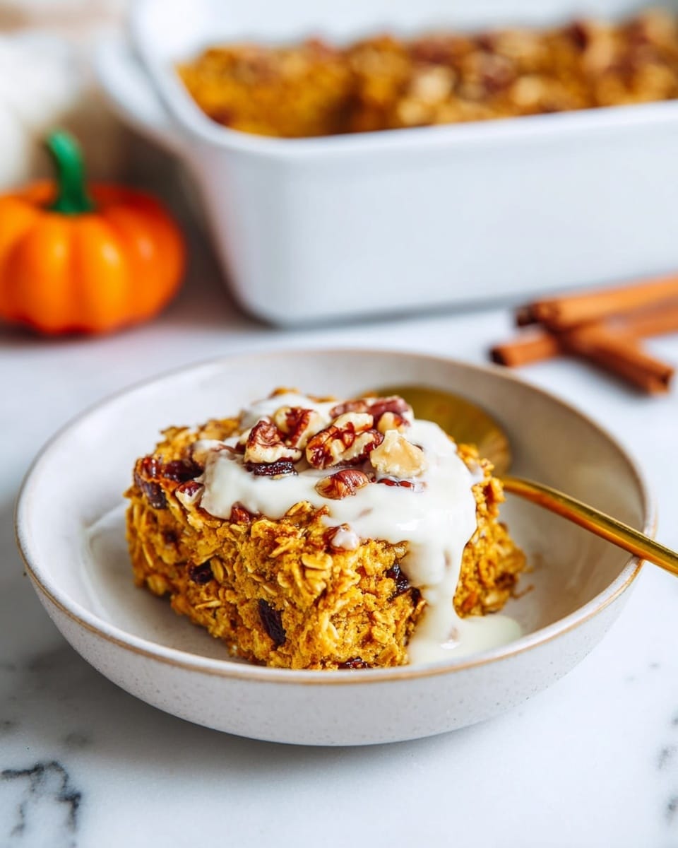 A square piece of oatmeal baked pudding with a rough, slightly crumbly texture and a golden brown color, sitting in the middle of a white bowl, topped with a thick layer of smooth white cream and small pieces of chopped nuts scattered on top. A gold spoon is placed on the right side of the bowl, partially under the pudding with a tiny scoop missing from the corner of the pudding where the spoon rests. The background is a white marbled surface, with an out-of-focus white baking dish filled with more pudding and some cinnamon sticks and a pumpkin-themed box blurred behind it. Photo taken with an iphone --ar 4:5 --v 7