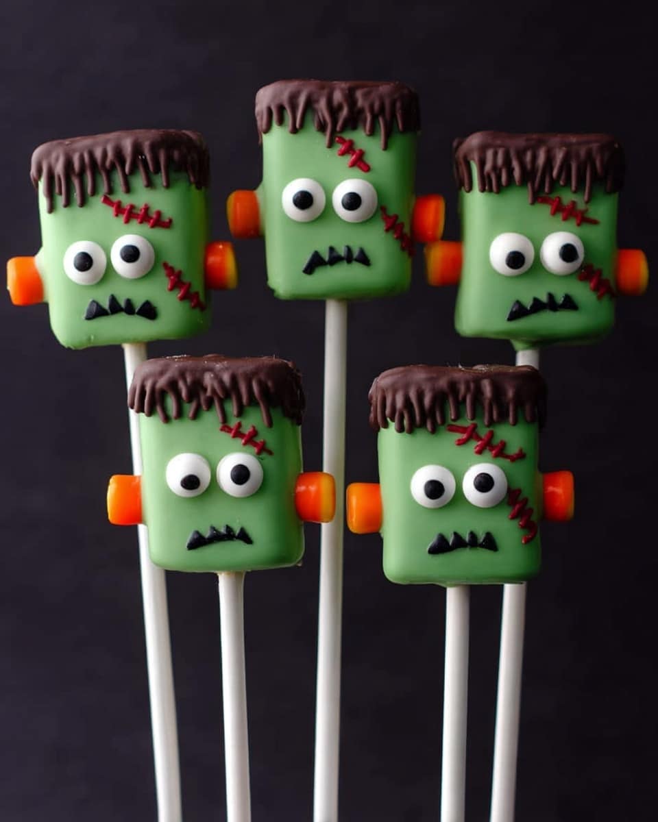 The image shows seven marshmallows decorated as green Frankenstein heads on white sticks. Each marshmallow is covered in smooth green icing as the main layer, with a top layer of wavy brown chocolate dripping over the edges to represent hair. Two round white candy eyes with black pupils are placed near the top center of each marshmallow. Below the eyes are uneven black squiggly lines for mouths, and red zigzag lines on one side of each head depicting scars. Small cylindrical brown candy pieces are attached on both sides of each marshmallow to look like bolts. The sticks are held upright with a white marbled surface background and dark backdrop. photo taken with an iphone --ar 4:5 --v 7