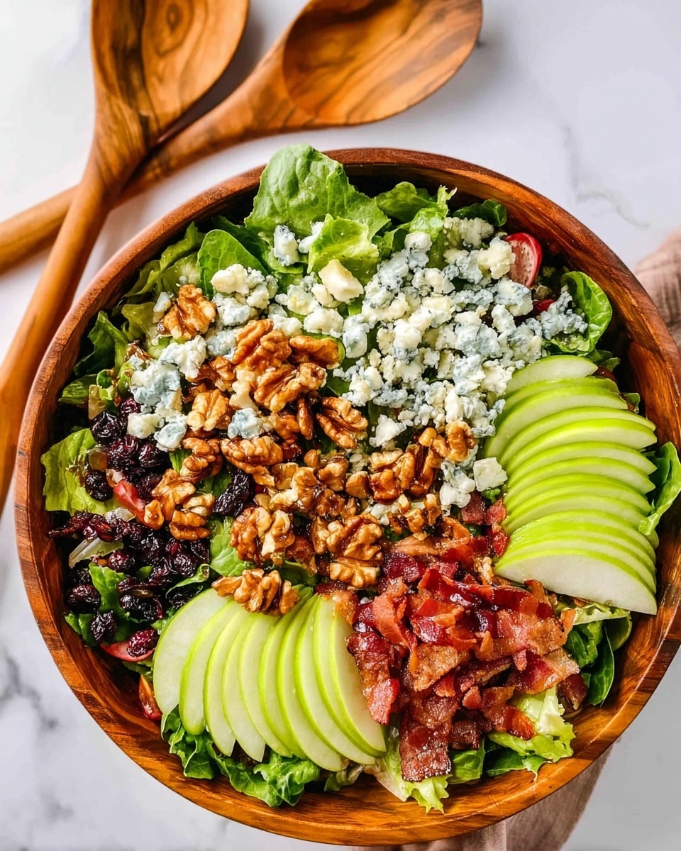 A wooden bowl filled with a fresh salad placed on a white marbled surface. The salad has a base layer of green leafy vegetables, topped with multiple layers including thin slices of green apple arranged in small stacks, clusters of walnuts drizzled with a glossy dressing, dark dried fruits scattered around, small pieces of crumbled blue cheese spread evenly, and crispy strips and chunks of cooked bacon lining the bowl's edge and mixed in the salad. Two wooden spoons lie on the white marbled surface next to the bowl. photo taken with an iphone --ar 4:5 --v 7