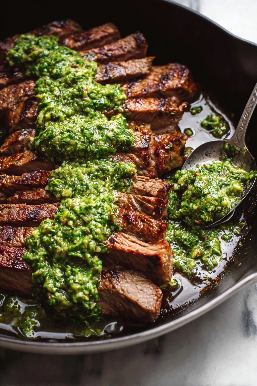 The image shows a thick, dark brown grilled steak sliced into several pieces and arranged in a slightly fanned-out way on a black pan. The top of the steak is covered with a rough-textured, bright green sauce spread unevenly across the pieces. Around the steak, there are small pools of the sauce and some oil, adding shine to the dish. A metal spoon with some of the green sauce rests on the edge of the pan. The pan sits on a white marbled surface. photo taken with an iphone --ar 4:5 --v 7