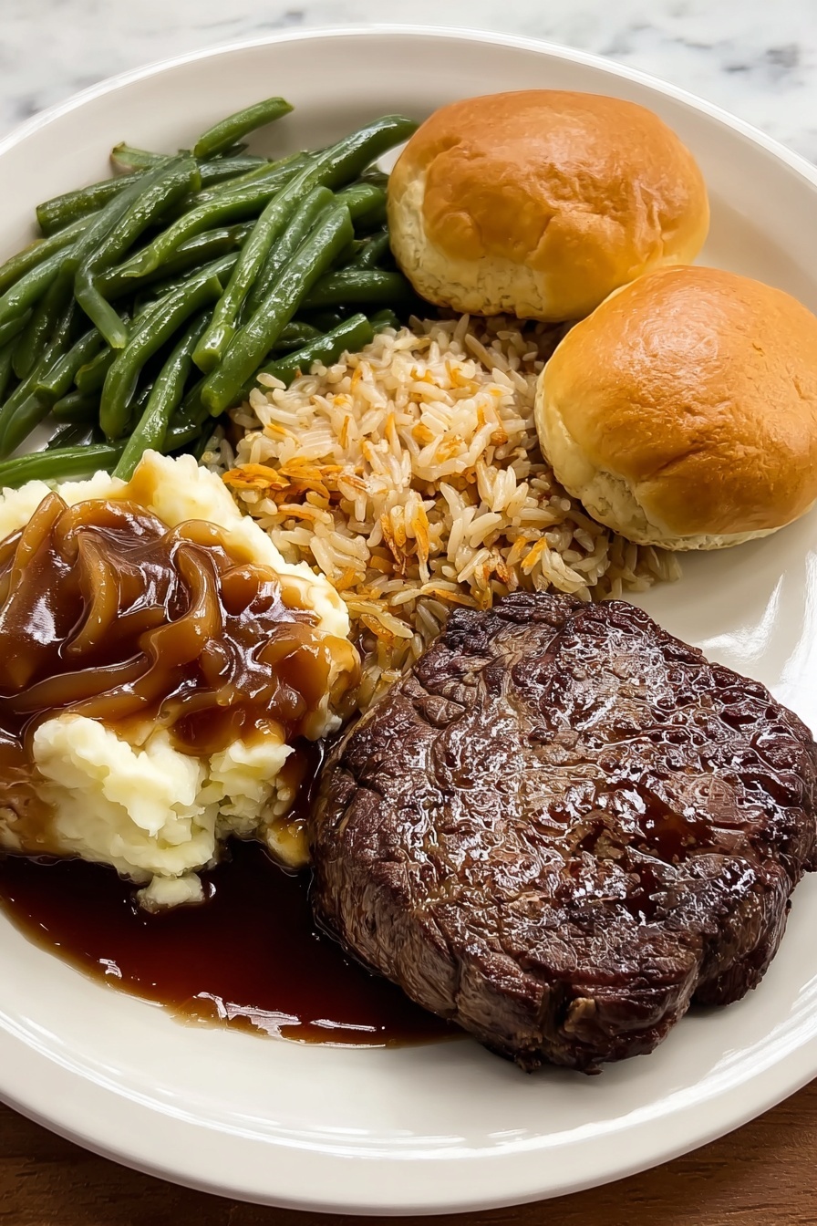 A white plate holds a meal with four main parts arranged around the edges. One side has a dark brown grilled steak with a shiny, slightly wet surface. Next to it are two small, round, golden-brown biscuits with a soft texture. Above the steak is a pile of green beans, glossy and cut into short pieces. Next to the beans is a serving of rice mixed with small brown bits, showing a light brown and tan color. On the left side of the plate is a scoop of mashed potatoes covered with smooth brown gravy that spreads slightly onto the plate. The plate sits on a white marbled surface. photo taken with an iphone --ar 4:5 --v 7
