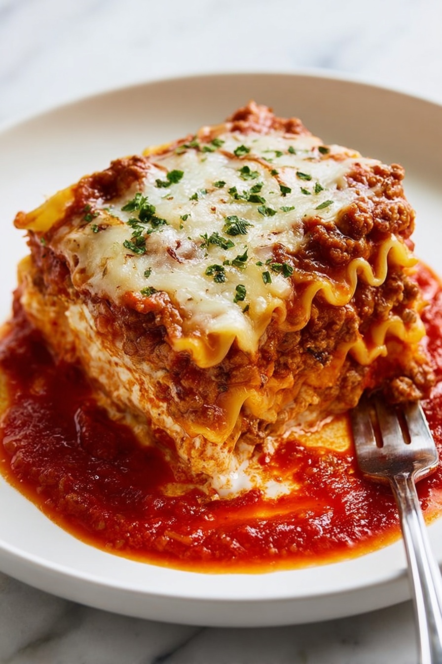 A square piece of lasagna sits on a white plate, showing around four visible layers. The bottom layer is red tomato sauce spreading around the piece on the plate. Above the sauce is a cooked ground meat layer mixed with a light orange cheese sauce. On top of this is a slightly ruffled, pale yellow lasagna noodle. Above the noodle is another layer of ground meat mixed with cheese, followed by a final noodle layer. The top is covered with a creamy melted white cheese with small green herb bits sprinkled across, and the edges of the cheese are slightly browned. A copper-colored fork is placed on the right side of the plate. The plate is on a white marbled surface. Photo taken with an iphone --ar 4:5 --v 7