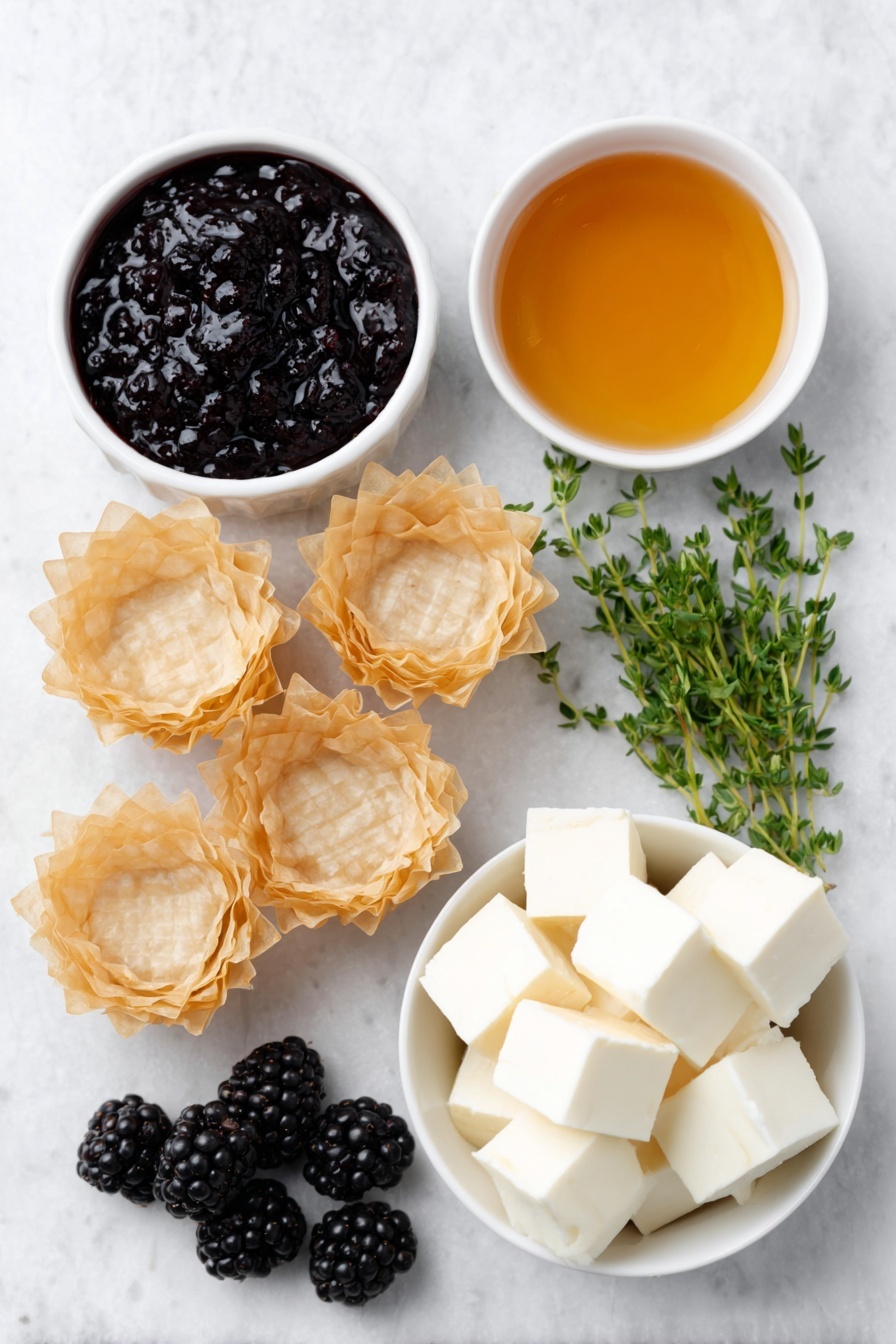 Flat lay of fresh golden mini phyllo shells arranged neatly, a small white ceramic bowl with glossy deep purple blackberry jam, another small white bowl filled with clear golden honey, creamy pale off-white cubes of brie cheese without rind, a handful of plump fresh blackberries with a rich dark purple hue, and a few sprigs of vibrant green fresh thyme artfully placed, all ingredients balanced symmetrically and naturally placed on a clean white marble surface, soft natural light, photo taken with an iPhone, professional food photography style, fresh ingredients, white ceramic bowls, no bottles, no duplicates, no utensils, no packaging --ar 2:3 --v 7 --p m7354615311229779997 - Brie and Blackberry Phyllo Cups, Brie and Blackberry Appetizer, Elegant BlackBerry Phyllo Bites, Easy Brie and Fruit Hors d'Oeuvre, Gourmet Brie Phyllo Cups